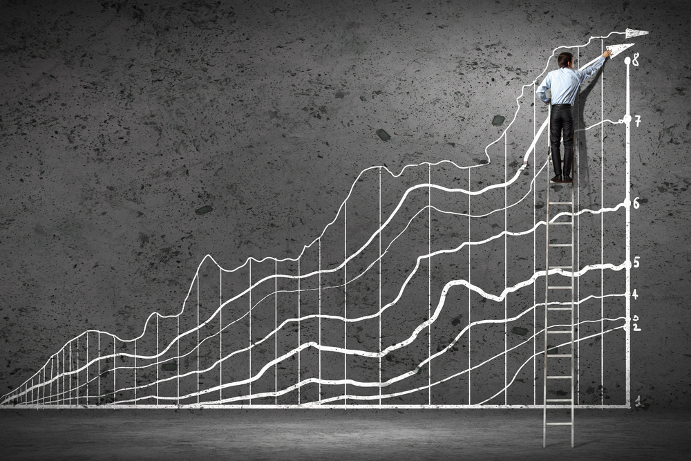 Back view image of businessman drawing graphics on wall-2